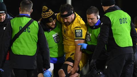 Dragons prop Rob Hunt is helped from the field after an injury against Ospreys