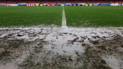 A waterlogged football pitch. 