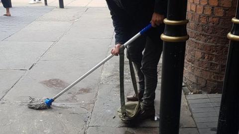 The image of the man cleaning as shared on social media