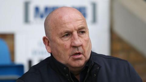 Gillingham boss John Coleman looks on from the touchline.