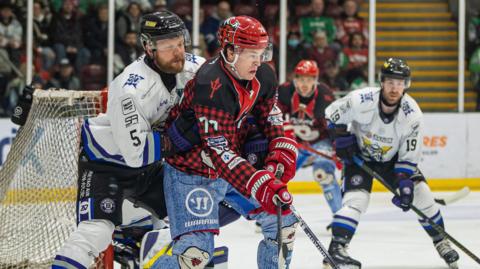 Players battle for the puck between Cardiff Devils and Manchester Storm