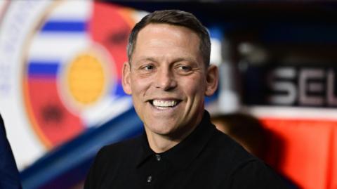 Reading boss Leam Richardson looks on from his position in the dugout 