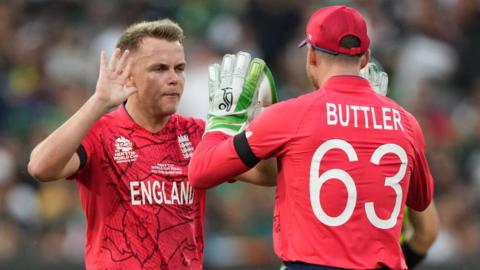 England's Sam Curran and Jos Buttler celebrate a wicket in the 2022 T20 World Cup final against Pakistan