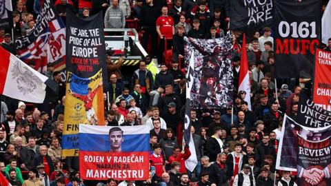 An image of a group of Manchester United fans inside Old Trafford