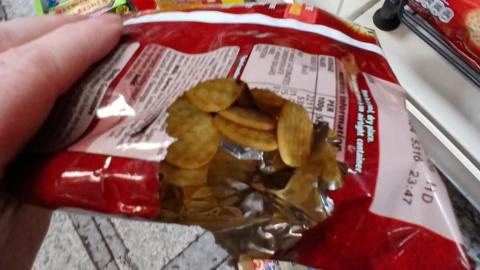 A close-up image of a broken packet of crisps showing its contents after it was gnawed away by mice