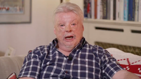 Falklands war veteran Simon Weston speaks to BBC Newsnight wearing a blue checkered shirt