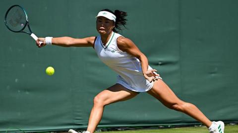 Mimi Xu returns a shot in the semi-finals of the girls' singles at Wimbledon