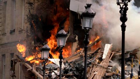 Smoke billows from rubbles of a building at Place Alphonse-Laveran in the 5th arrondissement of Paris, on 21 June 2023