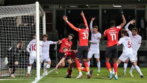 Barnsley players in action against Luton