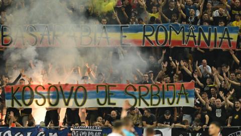 Romanian ultras display banners reading (in Serbian) "Kosovo is Serbia" and (in Romanian) "Bessarabia is Romania" during the Euro 2024 first round group I qualifying football match between Romania and Kosovo