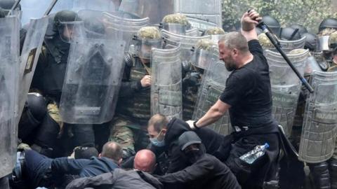 Nato Kosovo Force (KFOR) soldiers clash with local Kosovo Serb protesters at the entrance of the municipality office, in the town of Zvecan, Kosovo, May 29, 2023