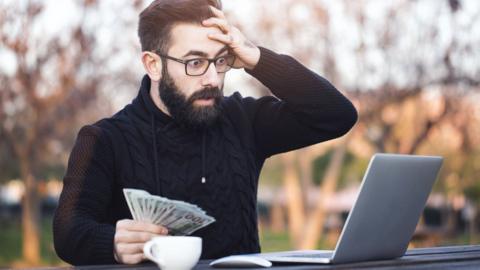 Shocked man looking at laptop