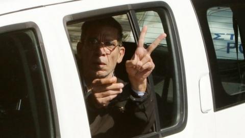 Mustafa giving a V-sign as he is driven away after the hijacking, March 2016