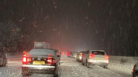 Cars in snow on M25 near M11 junction