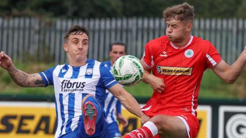 Coleraine's Joel Cooper in action against Harry Wilson of Cliftonville