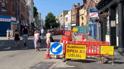 The centre of Gloucester, part of which is cordoned off behind orange barriers to allow for work on the cycle lane to be completed. 