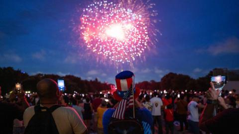 Revelers watch the fireworks display in front of the steps of the Lincoln Memorial in Washington, DC, on Independence Day, July 04, 2024. 