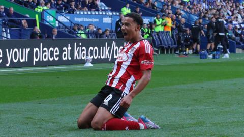 Kamari Doyle celebrating after scoring a free-kick against Bolton Wanderers