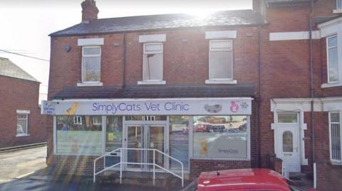 The entrance to Simply Cats Vet Clinic in Fence Houses, Sunderland, with a red vehicle parked outside