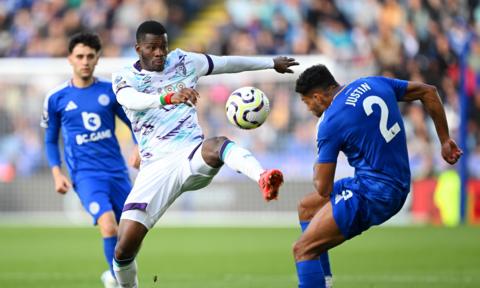 Dango Ouattara challenges James Justin for the ball.