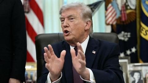 Trump gesticulates in the oval office