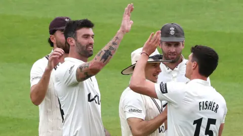 Matt Fisher celebrates Surrey's first wicket against Hampshire