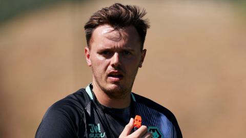 Jack Wilson holds an orange whistle during pre-season training with Wolves.