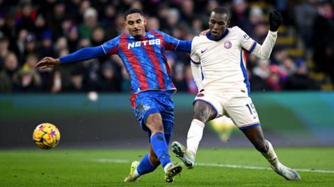 Nicolas Jackson of Chelsea shoots and misses whilst under pressure from Maxence Lacroix of Crystal Palace