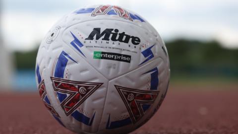 A National League football on an athletics track