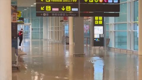 Floor partially submerged in flood water inside airport terminal