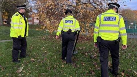 Police team using a metal detector