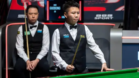 Xiao Guodong and Zhou Yuelong during their match at the World Snooker Championships