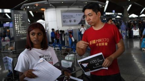 Grace Nathan (left), whose mother was onboard the missing Malaysia Airlines flight MH370, and Chinese national Jiang Hui - who also had a relative onboard the flight - at Kuala Lumpur International Airport (03 December 2016)