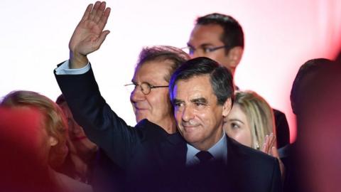 French presidential election candidate for the right-wing Les Republicains (LR) party Francois Fillon waves on March 2, 2017 during a public rally in Nimes,