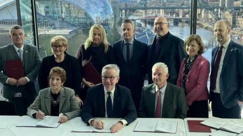 Levelling up secretary Michael Gove signs the North East devolution deal with local council leaders at the Baltic art gallery in Gateshead