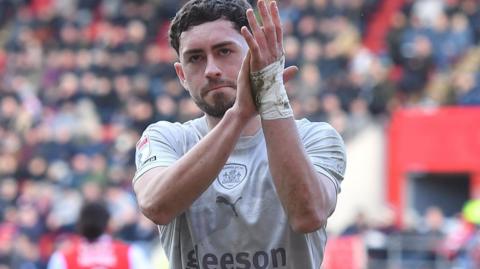 Corey O'Keeffe applauds the Barnsley fans
