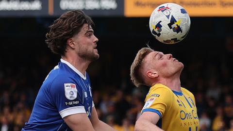 Will Evans battles for the ball for Mansfield against Cardiff