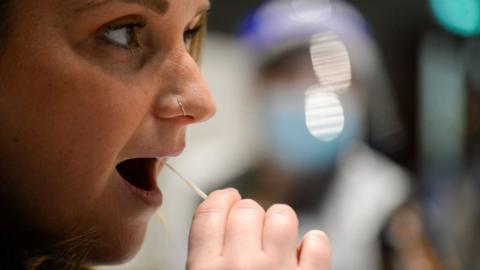 Woman taking a lateral flow Covid-19 test