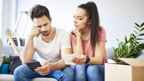 Man and woman looking at bills