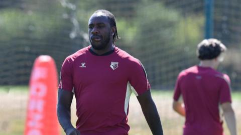 Michail Antonio, in a maroon Watford training top, pursing his lips