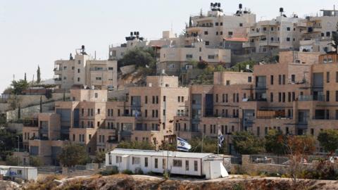 Buildings forming part of Nof Zion, a Jewish settlement in occupied East Jerusalem, are seen in the foreground as buildings from the Palestinian district of Jabal Mukaber are seen in the background (25 October 2017)