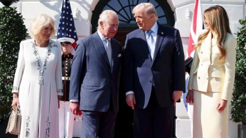 Queen Camilla, King Charles, Donald Trump and Melania Trump standing in a line outside the White House.