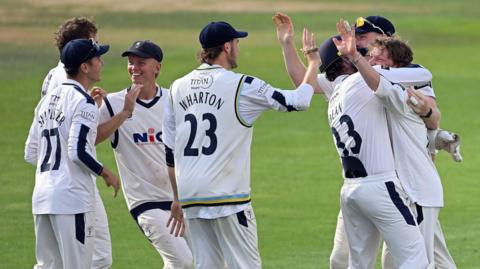 Yorkshire players mob stand-in skipper Dom Bess after a wicket