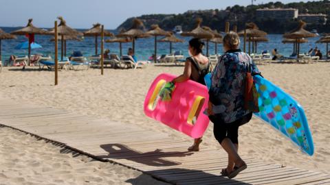 People arrive at Magaluf beach on July 30, 2020 in Mallorca, Spain.