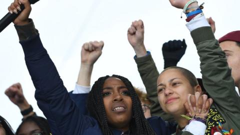 Marjory Stoneman Douglas High School student Emma Gonzalez(R) cheers with other students during the March for Our Lives Rally in Washington, DC on March 24, 2018.