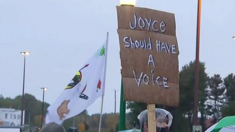 Protest banner saying "Joyce should have a voice"