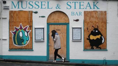 A boarded up restaurant in Edinburgh, the morning after stricter lockdown measures came into force for mainland Scotland.