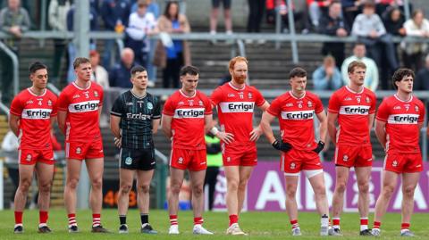 The Derry team stand for the anthem 