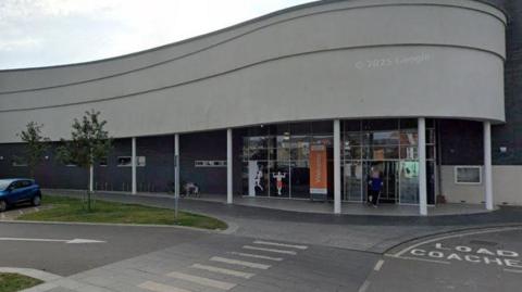 The exterior of Bridlington's sports centre. The atrium features a wave-like design, with a glass frontage 