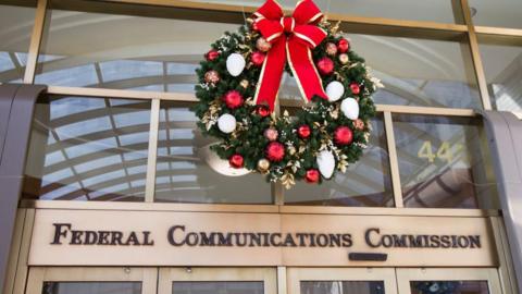 A Christmas wreath hangs above the entry to the Federal Communications Commission office